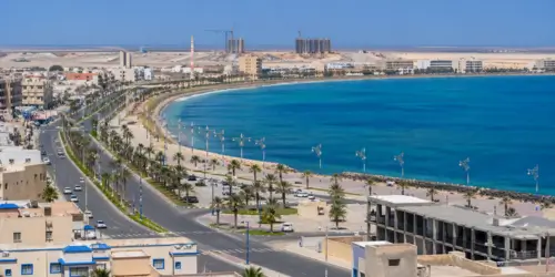 مشهد بانورامي لمدينة الداخلة على ساحل الأطلسي، يبرز المشاريع العمرانية الحديثة ودينامية التنمية في الصحراء المغربية.